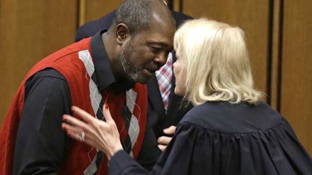 Kwame Ajamu gets a hug from Judge Pamela Barker after his name is cleared. (AAP)