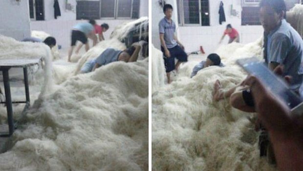 One worker at the Tongcheng Rice Noodle Factory was pictured sleeping on a bed of noodles, while others were caught with their feet in the food in a series of undercover photographs. (Supplied)`