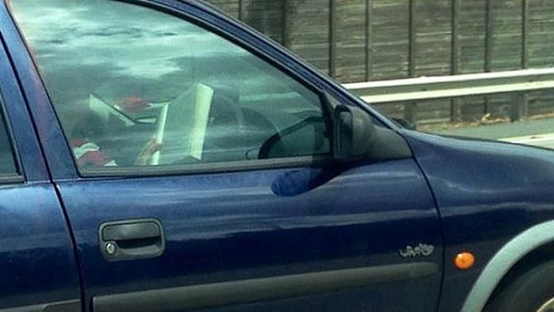 A driver caught on the M1 at Yatala while reading a novel. (Supplied)