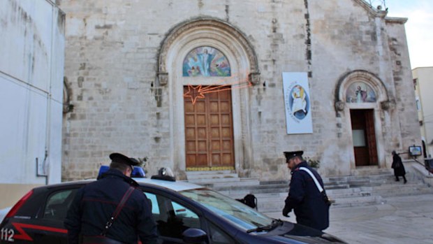 Police stand in front of the Italian church planning to hold mass for a suspected mafia boss. (AAP)
