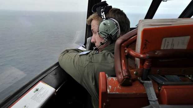 Flying Officer Benjamin Hepworth searches from a Royal Australian Airforce AP-3C Orion for possible MH370 debris. (Getty)
