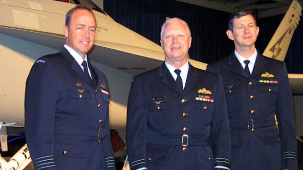 (L-R) Royal Australian Air Force (RAAF) Group Captain Steve Roberton, chief Air Marshal Mark Binskin and Wing Commander Glen Braz stand before the RAAF's first new Boeing Super Hornet at the rollout ceremony at the Boeing factory in St Louis, Missouri, United States, Wednesday, July 9, 2009. (AAP)