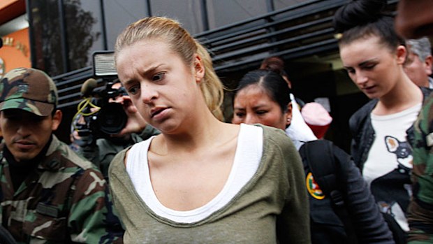 Police escort Melissa Reid, of Britain, front, and Michaella McCollum Connolly, of Ireland, behind right, from the National Police anti-drug headquarters to a court to be formally charged for drug trafficking in Lima, Peru, in 2013. (AAP)