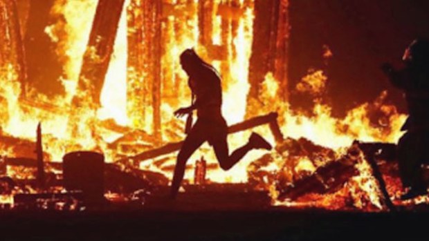 The man who broke through security runs into the blaze at the Burning Man Festival in Nevada. (Photo: Social media).