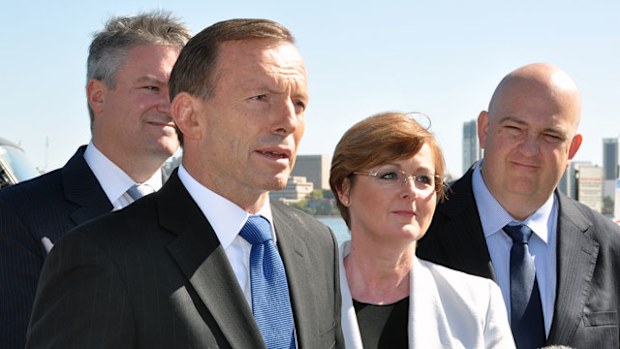 Prime Minister Tony Abbott speaks to the media with Finance Minister Mathias Cormann (left) and Senate candidates Linda Reynolds and Slade Brockman. (AAP)