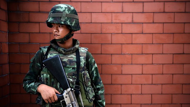 A Thai soldier stands outside the Government Public Relations Department after martial law was imposed in Bangkok. (Getty)