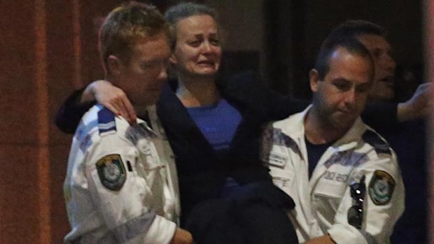 Mrs Mikhael being carried out by emergency services after police broke the 17 hour siege. (AAP)