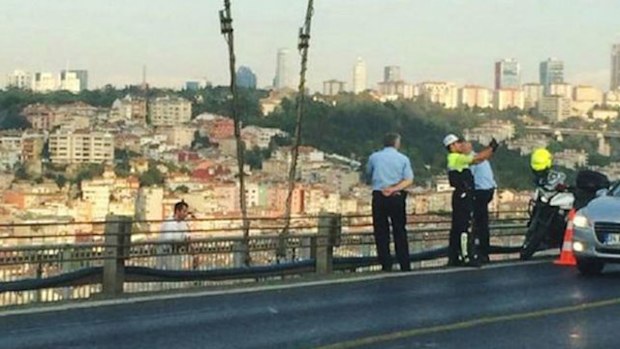 A Turkish police officer could face criminal charges after he was sprung posing for selfie moments with a suicide jumper moments before he fell to his death in the Turkish capital of Ankara. (Supplied)