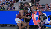 Lions star Charlie Cameron puts his shoulder into Pies defender Jeremy Howe.