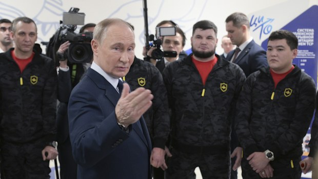Russian President Vladimir Putin meets with servicemen wounded in Russia's special military operation in Ukraine and undergoing rehabilitation during a visit to the Priorov National Medical Research Center of Traumatology and Orthopaedics on the International Day of Persons with Disabilities in Moscow, Russia, Tuesday, Dec. 3, 2024. (Vladimir Astapkovich, Sputnik, Kremlin Pool Photo via AP)