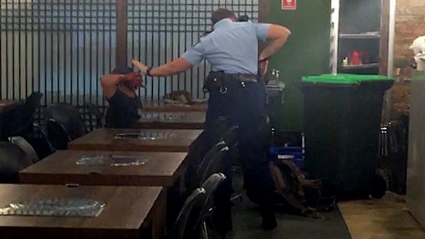 Alexander Villaluna being arrested in the Horsby restaurant in March last year. (AAP)