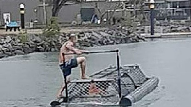 One man climbs on the croc trap. (Facebook).