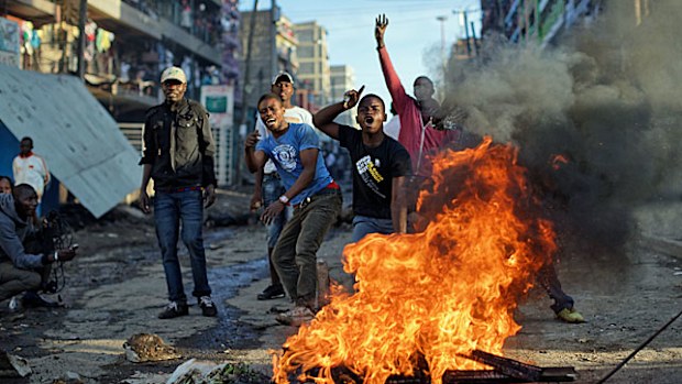 Opposition supporters taunt police in a part of Nairobi. (Photo: AP).