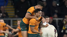 Australia's Len Ikitau (right) and Joseph Suaalii celebrate after teammate Max Jorgensen (not pictured) scored. 