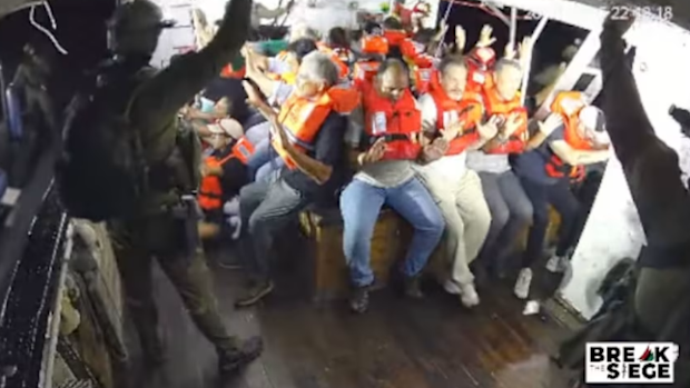 A still from a YouTube livestream shows armed Israeli personnel intercepting the Handala aid ship en route to Gaza.