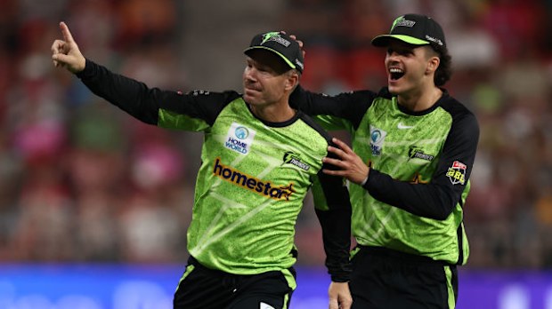 David Warner of the Thunder celebrates with Sam Konstas.