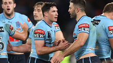 Mitchell Moses and James Tedesco of the Blues celebrate winning game three of the State of Origin series.