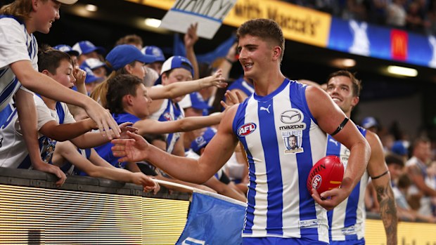 Harry Sheezel celebrates with fans after North Melbourne defeated the West Coast Eagles.