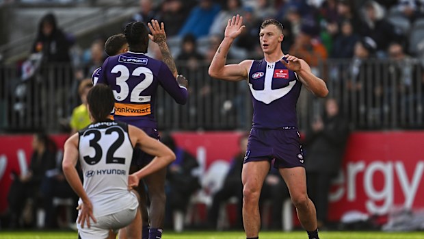 Josh Treacy of the Dockers celebrates a goal.