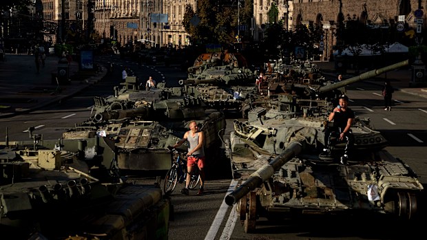 People walk around destroyed Russian military vehicles installed in downtown Kyiv, Ukraine, Wednesday, Aug. 24, 2022. Kyiv authorities have banned mass gatherings in the capital through Thursday for fear of Russian missile attacks. Independence Day, like the six-month mark in the war, falls on Wednesday. (AP Photo/Evgeniy Maloletka)
