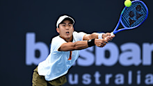 BRISBANE, AUSTRALIA - JANUARY 08: Rinky Hijikata of Australia  plays a backhand in his second round Men's Singles match against Giovanni Mpetshi Perricard of France during day five of the 2026 Brisbane International at Pat Rafter Arena on January 08, 2026 in Brisbane, Australia. (Photo by Albert Perez/Getty Images)
