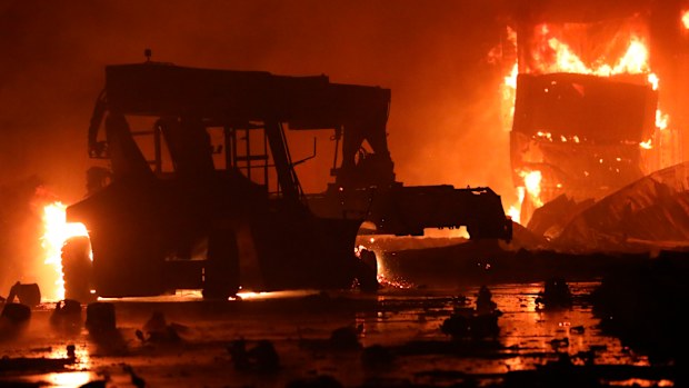 A fire rages at the BM Inland Container Depot, early Sunday, June 5, 2022. Dozens have been killed and more than 100 others injured in the fire the cause of which could not be immediately determined. (AP Photo)