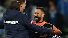 Victory goalkeeper Paul Izzo celebrates with team mates.