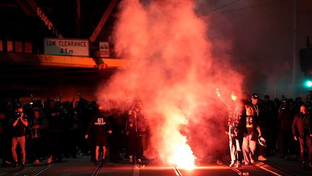 Stadium-goers let off flares in the streets ahead of the A-League Men grand final. 