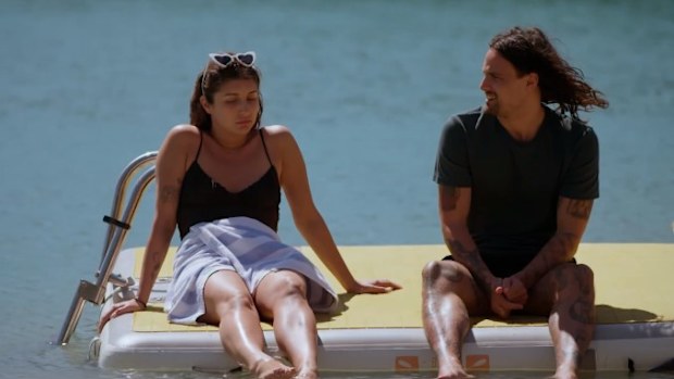 Claire and Jesse sit and have a talk on the water after not seeing each other all day.