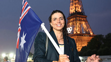 Jessica Fox, Flagbearer of Team Australia, poses with her flag on a boat along the River Seine during the opening ceremony of the Olympic Games Paris 2024.