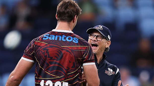 Reds coach Les Kiss interacts with a player.