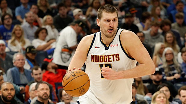 Nikola Jokic dribbles the ball.