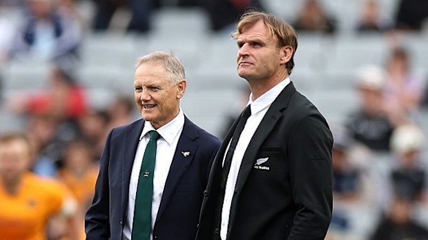 Coach Joe Schmidt of Australia talks with coach Scott Robertson of New Zealand.