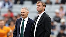 Coach Joe Schmidt of Australia talks with coach Scott Robertson of New Zealand.