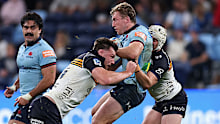 Harry Potter of the Waratahs is tackled.