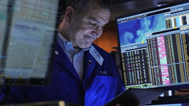 Trader Christopher Lagana works on the floor of the New York Stock Exchange, Friday, April 11, 2025. (AP Photo/Richard Drew)