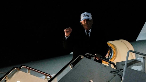 US President Donald Trump gestures while disembarking Air Force One after returning from Florida, Sunday, Jan. 11, 2026.