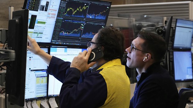 A pair of options traders work on the floor of the New York Stock Exchange, Friday, April 11, 2025. (AP Photo/Richard Drew)