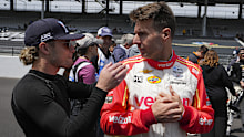 Santino Ferrucci talks with Will Power of Australia before the start of practice for the Indianapolis 500.