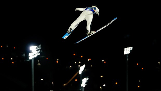 Domen Prevc, of Slovenia, soars through the air during his first round jump of the ski jumping men's super team competition at the 2026 Winter Olympics, in Predazzo, Italy, Monday, Feb. 16, 2026. (AP Photo/Matthias Schrader)