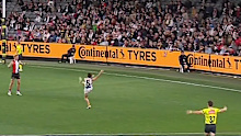 Nick Watson kicks for goal as the umpire calls play on.