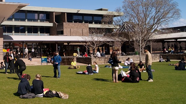 "Sydney, Australia - August 17, 2012: Students and graduates converge on a lawn before the University of New South Wales (UNSW) library on a clear winter morning."