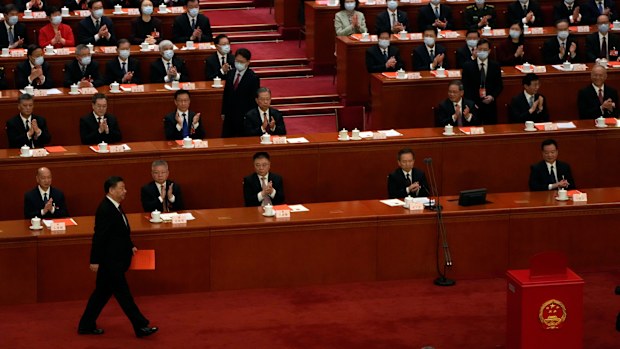 Chinese President Xi Jinping walks to cast his vote during a session of China's National People's Congress