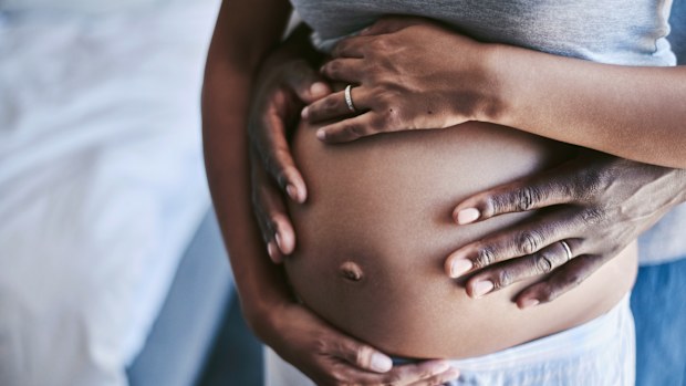 Cropped shot of an unrecognizable man and his wife touching her pregnant belly