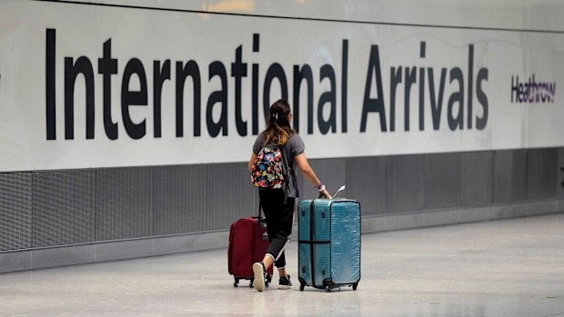 A passenger arrives from a flight at Terminal 5 of Heathrow Airport in London, Monday, August 2, 2021. 