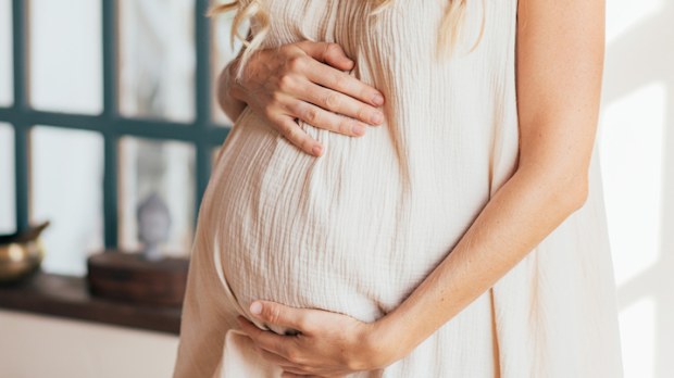 Pregnant woman holding her bump