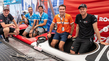Pat Cash (second from right) gets familiar with a SailGP vessel on board with Switzerland's Aussie sailing star Nathan Outteridge (far right).