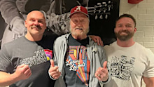 Dennis Condrey poses for a photo with current tag team FTR.