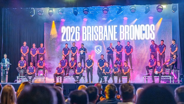 The Broncos squad and coach Michael Maguire on stage at the season launch.