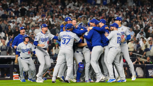 Members of the Los Angeles Dodgers celebrate on the field after the Dodgers defeated the New York Yankees in Game 5 to clinch the 2024 World Series.